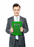 Businessman Showing Big Calculator Stock Photo