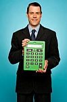 Businessman Showing Calculator Stock Photo