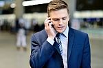 Businessman Talking On Phone Outdoors Stock Photo