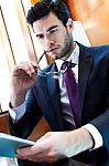 Businessman Using Digital Tablet In Office Stock Photo