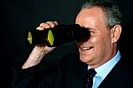 Businessman with binoculars Stock Photo