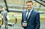 Businessman With Coffee Sipper Stock Photo