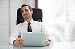 Businessman With Earphones Stock Photo