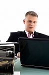 Businessman With Laptop And Files Stock Photo