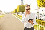 Businessman With Mobile Phone And Tablet In Hands Stock Photo