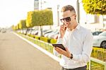 Businessman With Mobile Phone And Tablet In Hands Stock Photo