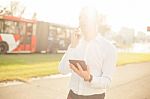 Businessman With Mobile Phone Tablet In Hands Stock Photo