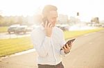 Businessman With Mobile Phone Tablet In Hands Stock Photo