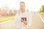 Businessman With Mobile Phone Tablet In Hands Stock Photo