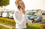 Businessman With Mobile Phone Tablet In Hands Stock Photo