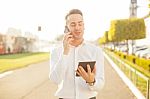 Businessman With Mobile Phone Tablet In Hands Stock Photo