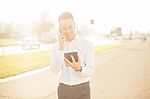 Businessman With Mobile Phone Tablet In Hands Stock Photo