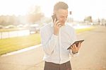 Businessman With Mobile Phone Tablet In Hands Stock Photo