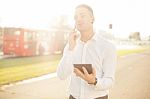 Businessman With Mobile Phone Tablet In Hands Stock Photo