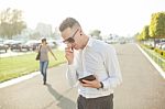 Businessman With Mobile Phone Tablet In Hands Stock Photo