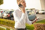 Businessman With Mobile Phone Tablet In Hands Stock Photo