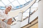 Businessman With Tablet Computer In Modern Business Building Stock Photo