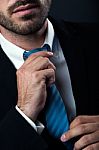 Businessman Without Face Straightens Tie Yourself. Isolated On B Stock Photo