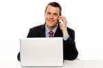 Businessman Working And Talking On Cell Phone Stock Photo