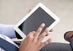 Businessman Working On Tablet With Crossed Legs Stock Photo