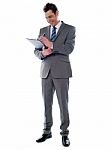 Businessman Writing On Clipboard Stock Photo