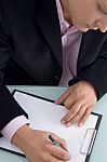 Businessman Writing On Clipboard Stock Photo