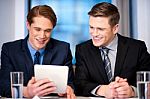 Businessmen Browsing On Tablet Device Stock Photo