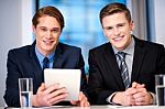 Businessmen Browsing On Tablet Device Stock Photo