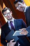 Businessmen With Digital Tablet  In Modern Office Stock Photo