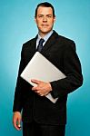 Businessperson Holding Laptop Stock Photo