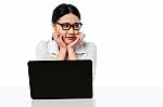 Businesswoman At Her Work Desk, Looking Away Stock Photo