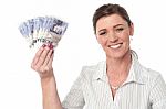 Businesswoman Holding Fan Of Currency Notes Stock Photo