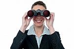 Businesswoman Looking Through Binocular Stock Photo