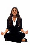 Businesswoman Meditating In Lotus Posture Stock Photo