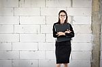 Businesswoman Standing Holding A File  In A Brick Building Stock Photo