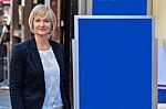 Businesswoman Standing Next To Flip Board Stock Photo