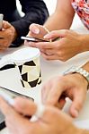 Businesswoman Using Mobile Phone At A Meeting Stock Photo