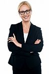 Businesswoman With Crossed Arms Wearing Glasses Stock Photo