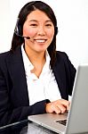 Businesswoman With Headset And Pc Stock Photo