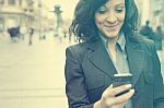 Businesswoman With Smartphone Walking On Street Stock Photo