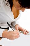 Businesswoman writing on Papers Stock Photo