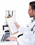 Busy Doctor Working With His Reports Stock Photo