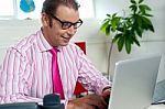 Busy Employee In Office Working On Laptop Stock Photo