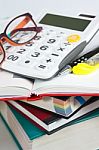 Calculator And Pen On Book Stack Stock Photo