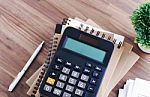 Calculator With Notebook Background Stock Photo