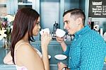 Casual Couple Having Coffee Together At The Coffee Shop Stock Photo