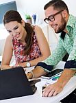 Casual Executives Working Together At A Meeting With Laptop Stock Photo