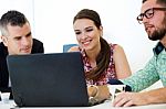 Casual Executives Working Together At A Meeting With Laptop Stock Photo