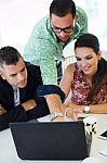 Casual Executives Working Together At A Meeting With Laptop Stock Photo