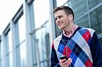 Casual Man Hearing Music Outside Modern Building Stock Photo